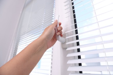 Photo of Woman opening window at home, low angle view