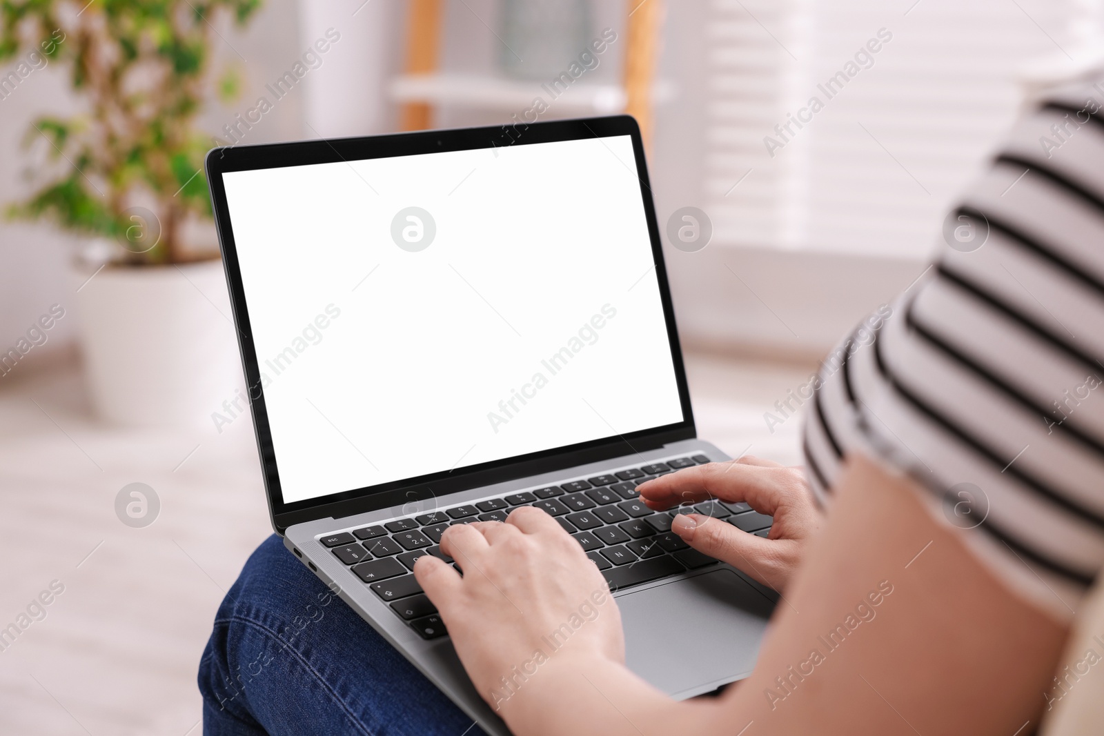 Photo of Woman working with laptop indoors, closeup. Mockup for design