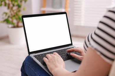 Photo of Woman working with laptop indoors, closeup. Mockup for design
