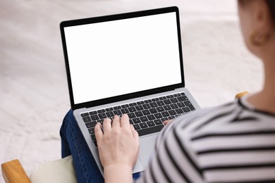 Photo of Woman working with laptop indoors, closeup. Mockup for design