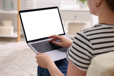 Photo of Woman working with laptop indoors, closeup. Mockup for design