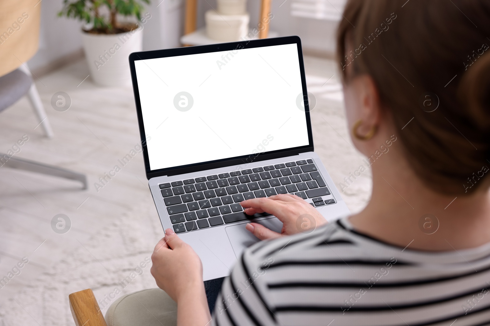 Photo of Woman working with laptop indoors, closeup. Mockup for design