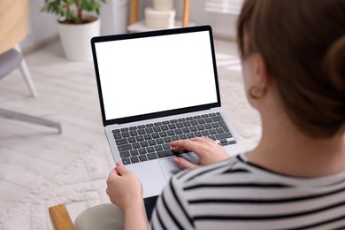 Photo of Woman working with laptop indoors, closeup. Mockup for design