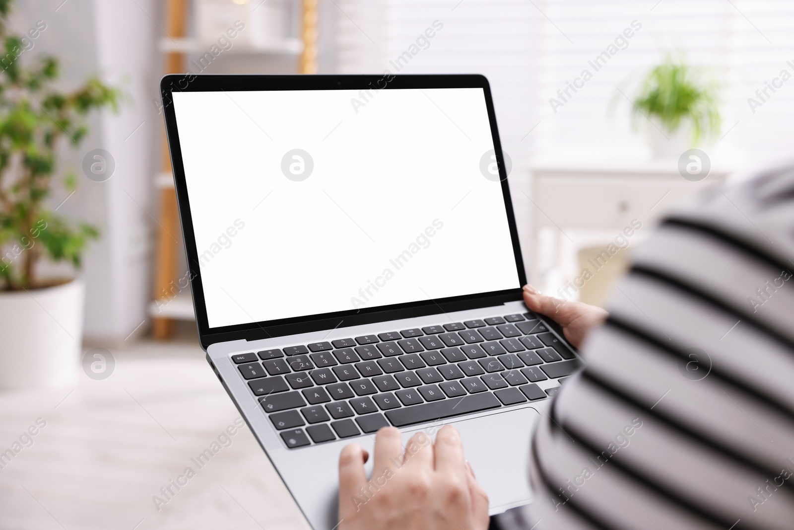 Photo of Woman working with laptop indoors, closeup. Mockup for design