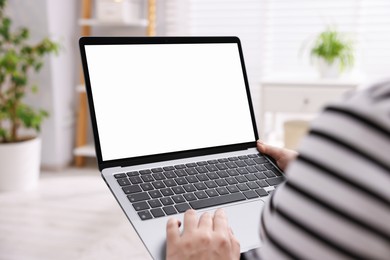 Photo of Woman working with laptop indoors, closeup. Mockup for design