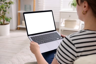 Photo of Woman working with laptop indoors, closeup. Mockup for design