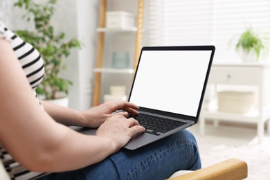 Photo of Woman working with laptop indoors, closeup. Mockup for design