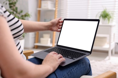 Photo of Woman working with laptop indoors, closeup. Mockup for design
