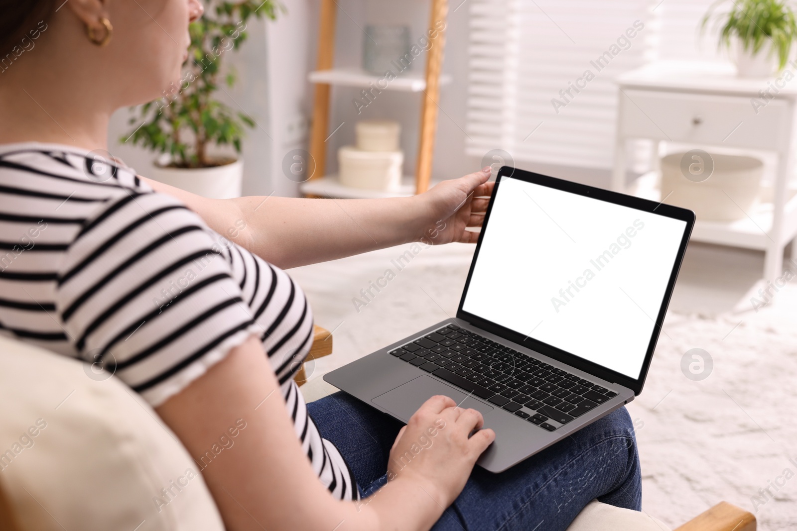 Photo of Woman working with laptop indoors, closeup. Mockup for design