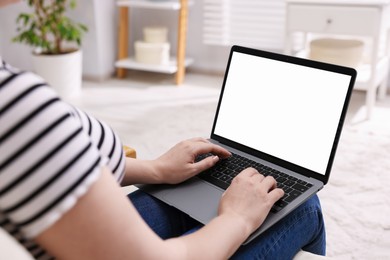 Photo of Woman working with laptop indoors, closeup. Mockup for design
