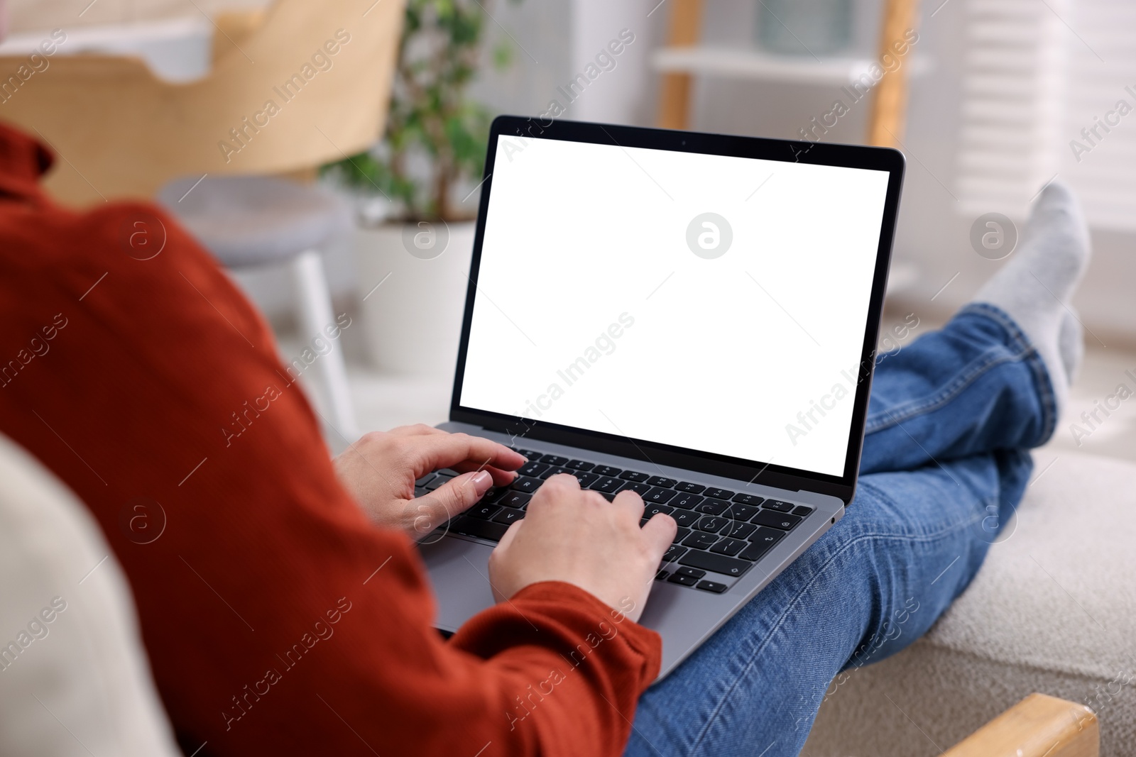 Photo of Woman working with laptop indoors, closeup. Mockup for design