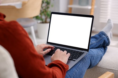 Photo of Woman working with laptop indoors, closeup. Mockup for design