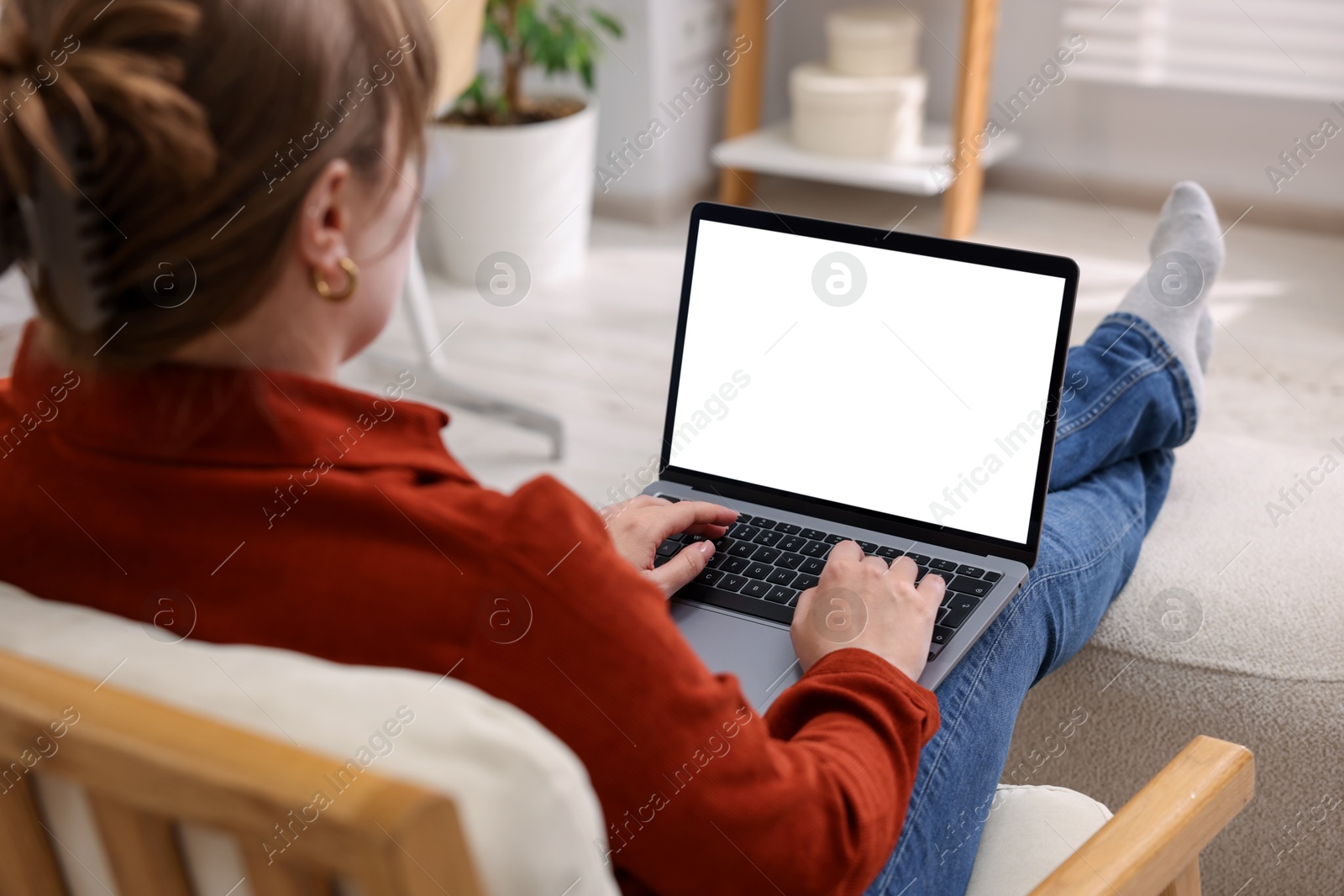 Photo of Woman working with laptop indoors, closeup. Mockup for design