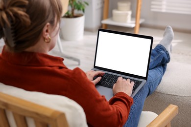 Photo of Woman working with laptop indoors, closeup. Mockup for design