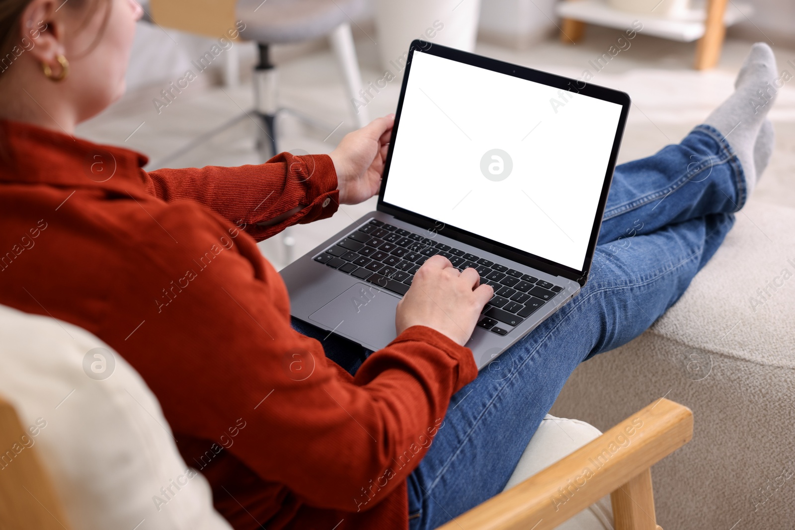 Photo of Woman working with laptop indoors, closeup. Mockup for design