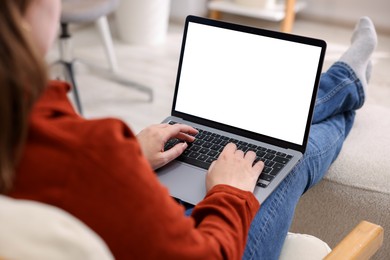 Photo of Woman working with laptop indoors, closeup. Mockup for design