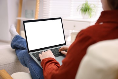 Photo of Woman working with laptop indoors, closeup. Mockup for design