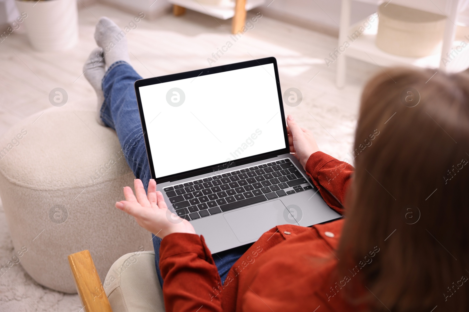 Photo of Woman working with laptop indoors, closeup. Mockup for design