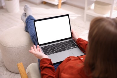 Photo of Woman working with laptop indoors, closeup. Mockup for design