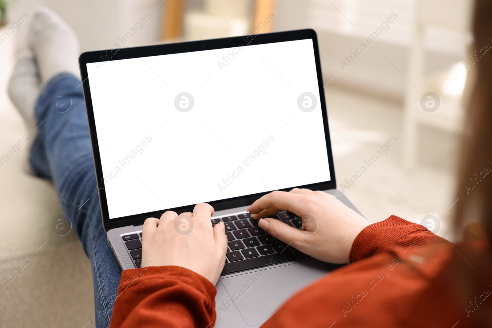 Photo of Woman working with laptop indoors, closeup. Mockup for design