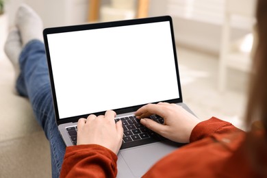 Photo of Woman working with laptop indoors, closeup. Mockup for design