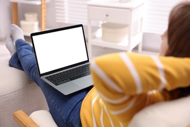 Photo of Woman working with laptop indoors, closeup. Mockup for design