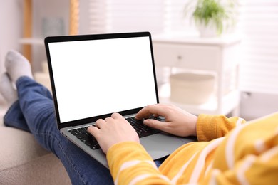 Photo of Woman working with laptop indoors, closeup. Mockup for design