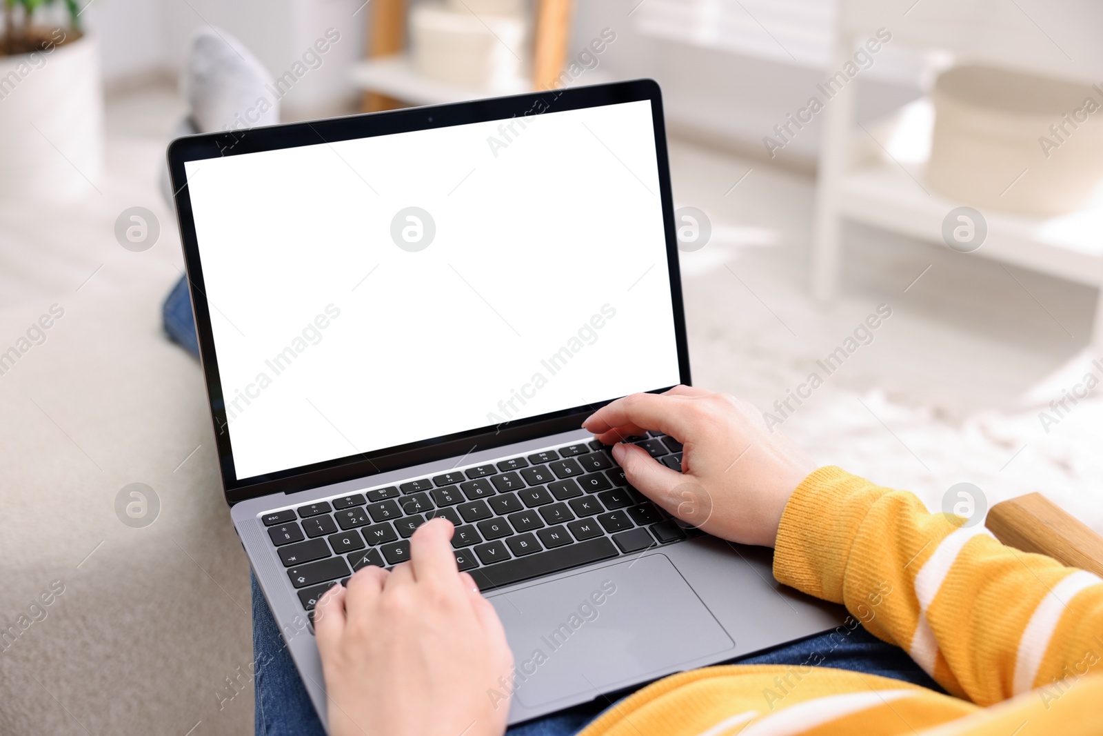 Photo of Woman working with laptop indoors, closeup. Mockup for design
