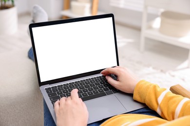 Photo of Woman working with laptop indoors, closeup. Mockup for design