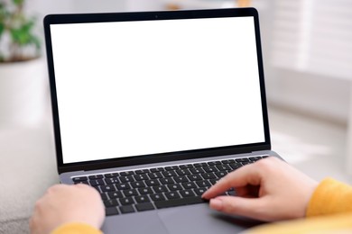 Photo of Woman working with laptop indoors, closeup. Mockup for design
