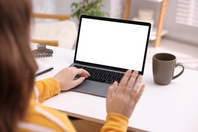 Photo of Woman working with laptop at white table indoors, closeup. Mockup for design