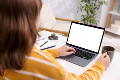 Photo of Woman working with laptop at white table indoors, closeup. Mockup for design