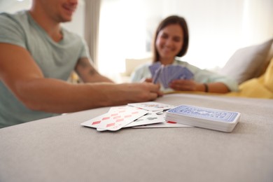 Photo of People playing cards at home, selective focus