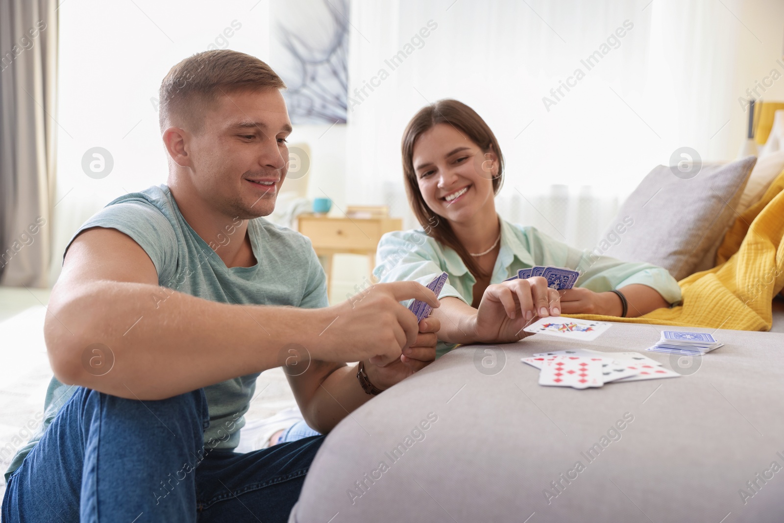Photo of Man and woman playing cards at home