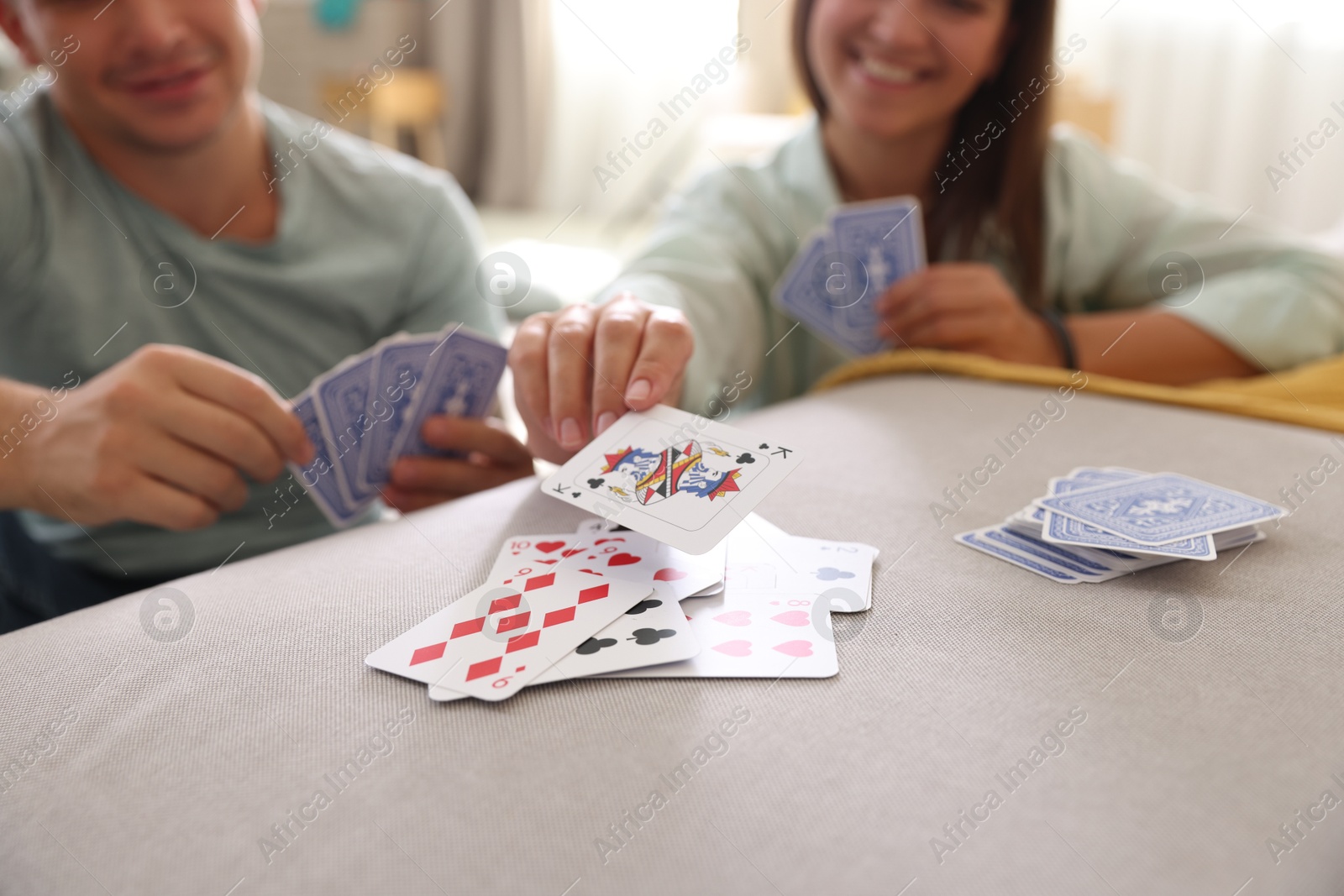 Photo of People playing cards at home, selective focus