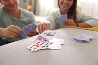 Photo of People playing cards at home, selective focus