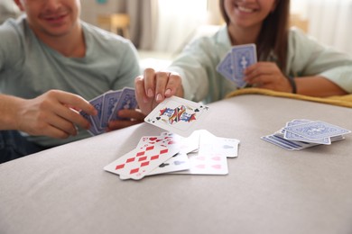 Photo of People playing cards at home, selective focus