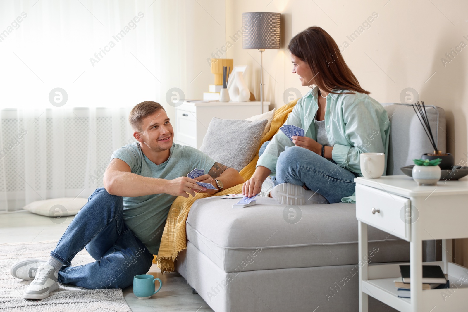 Photo of Man and woman playing cards at home