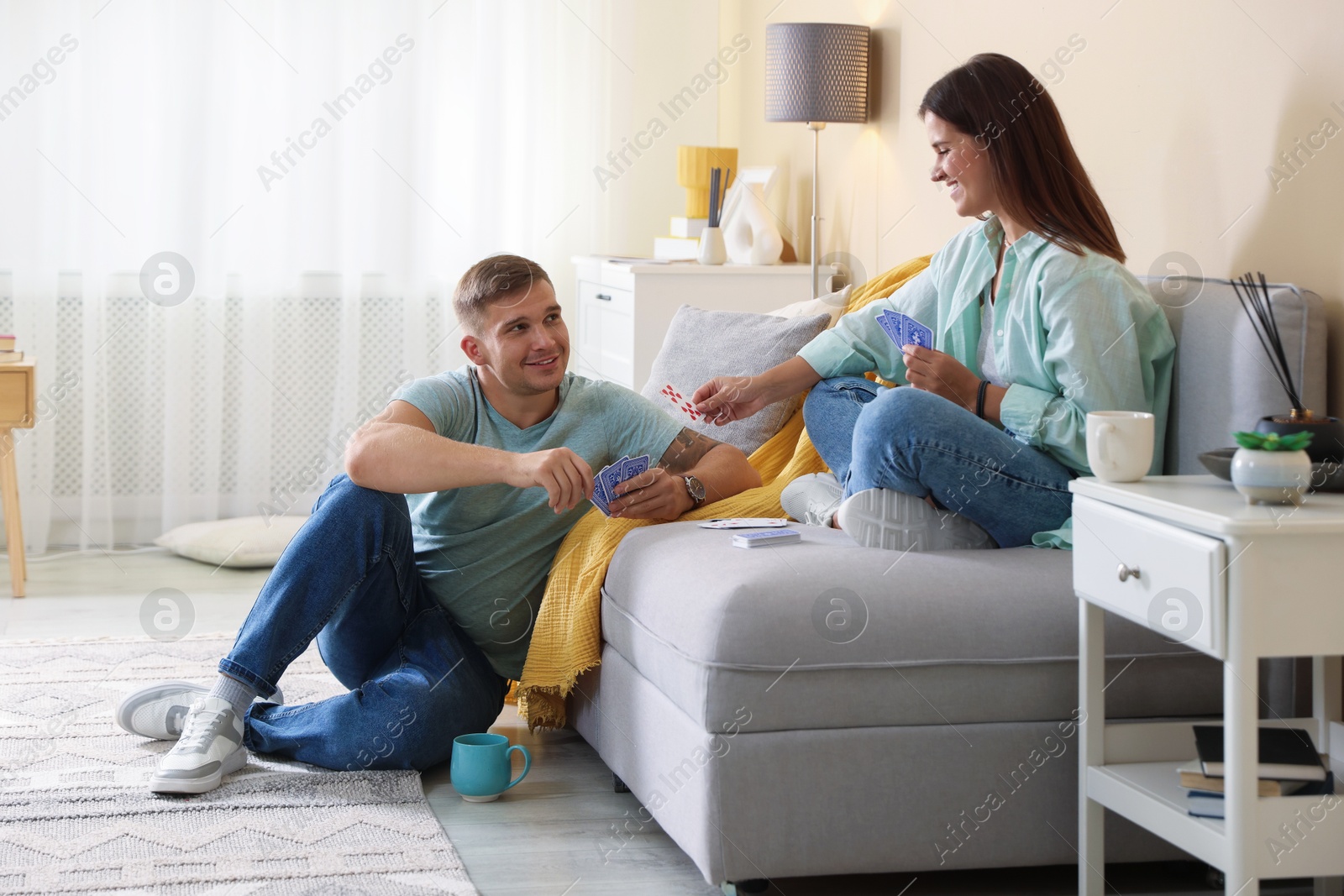 Photo of Man and woman playing cards at home