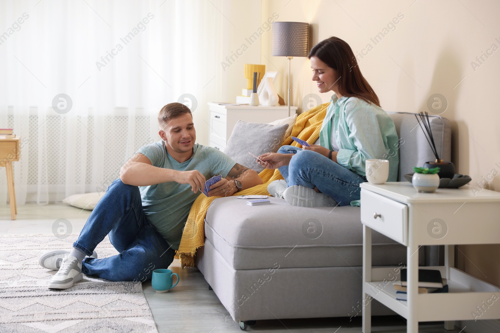 Photo of Man and woman playing cards at home