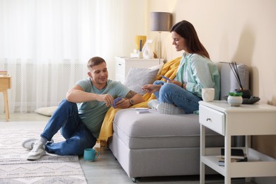 Photo of Man and woman playing cards at home