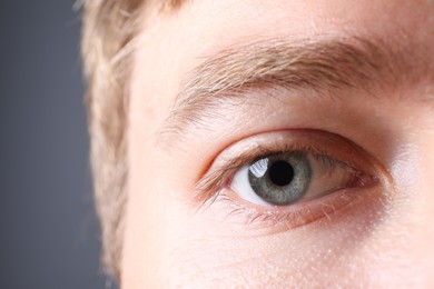 Photo of Man with beautiful eyes on grey background, closeup