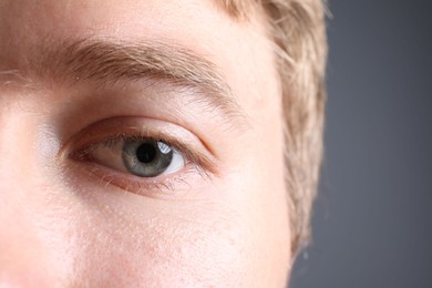 Photo of Man with beautiful eyes on grey background, closeup