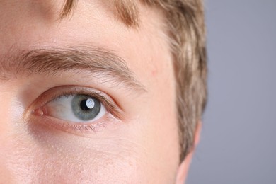 Photo of Man with beautiful eyes on light grey background, closeup