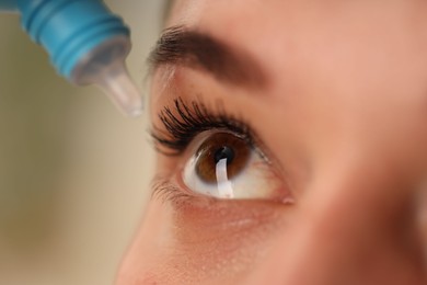 Photo of Woman applying eye drops on blurred background, closeup