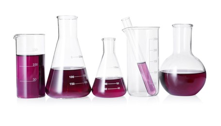 Photo of Different laboratory glassware with color liquid isolated on white