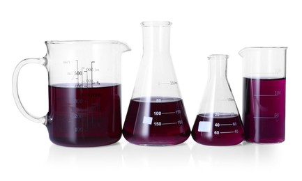 Photo of Different laboratory glassware with color liquid isolated on white