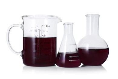 Photo of Different laboratory glassware with color liquid isolated on white