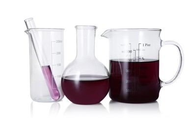 Photo of Different laboratory glassware with color liquid isolated on white