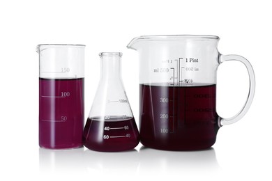 Photo of Different laboratory glassware with color liquid isolated on white